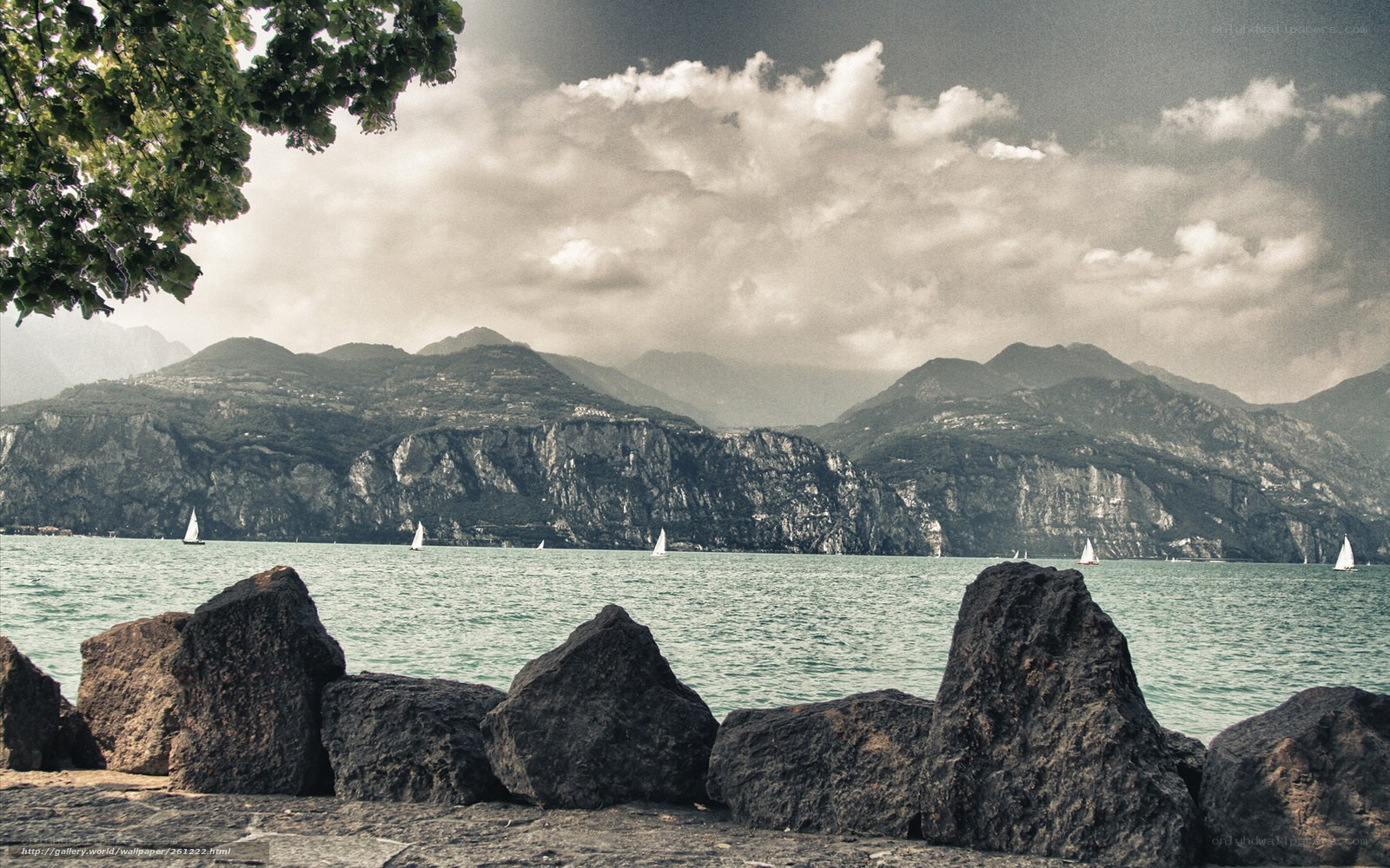 Lake with sailboats and mountains