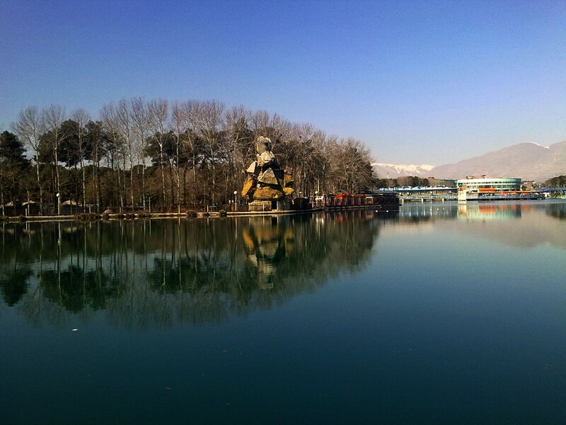Lake with sculpture and mountains