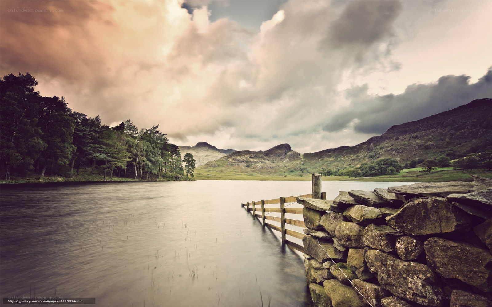 Lake with stone wall and mountains