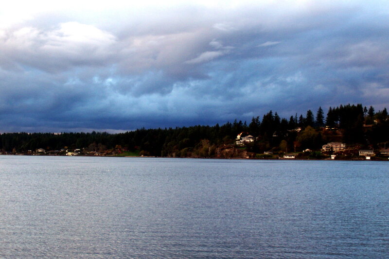 Lake with stormy sky and houses
