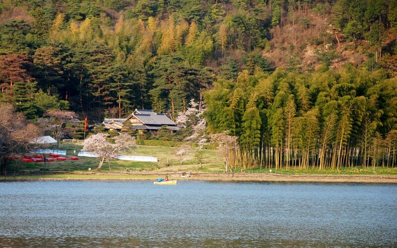 Lake with traditional house and bamboo grove