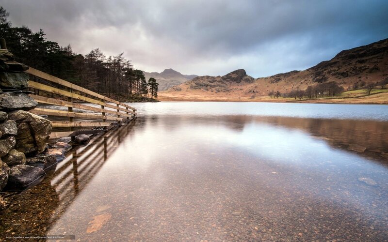 Lake with wooden bridge and mountains