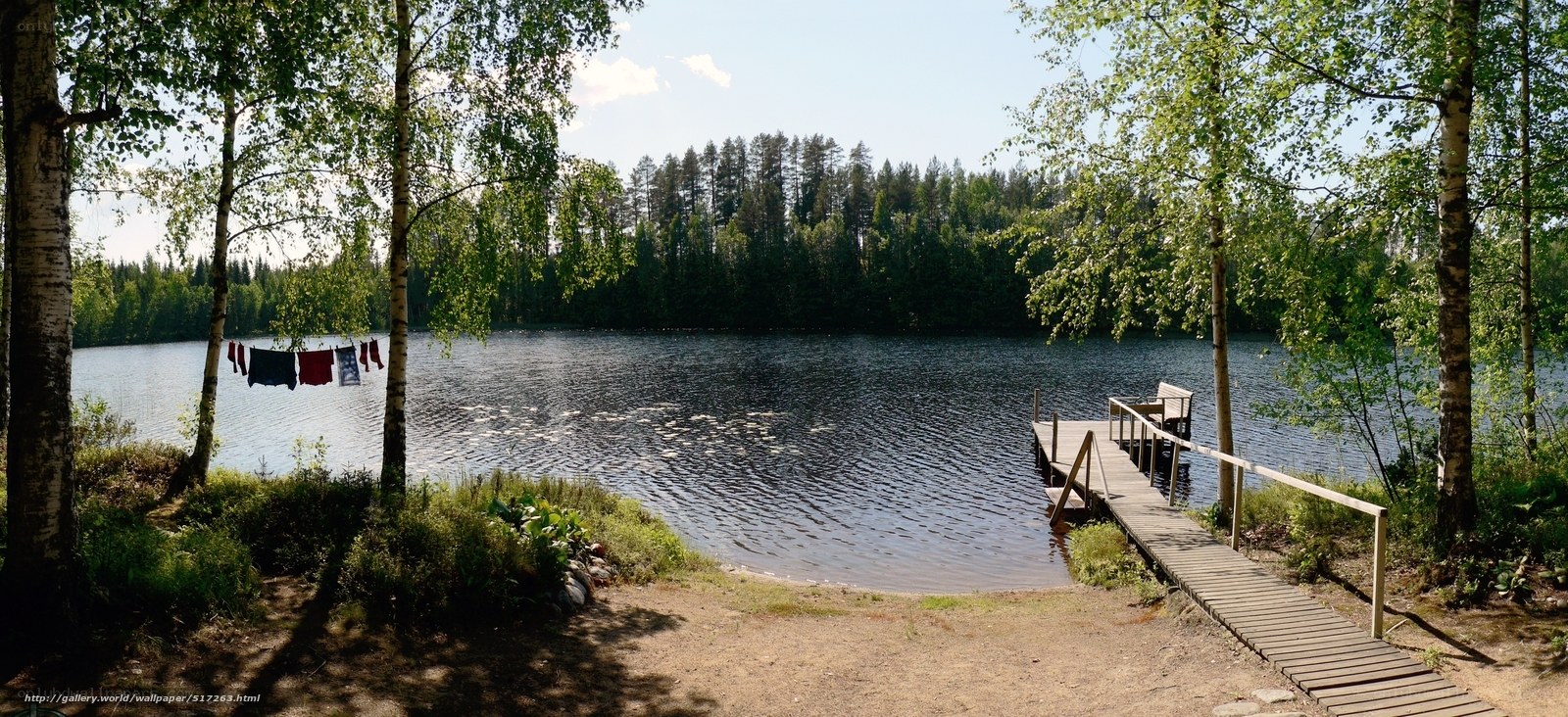 Lake with wooden dock and clothesline
