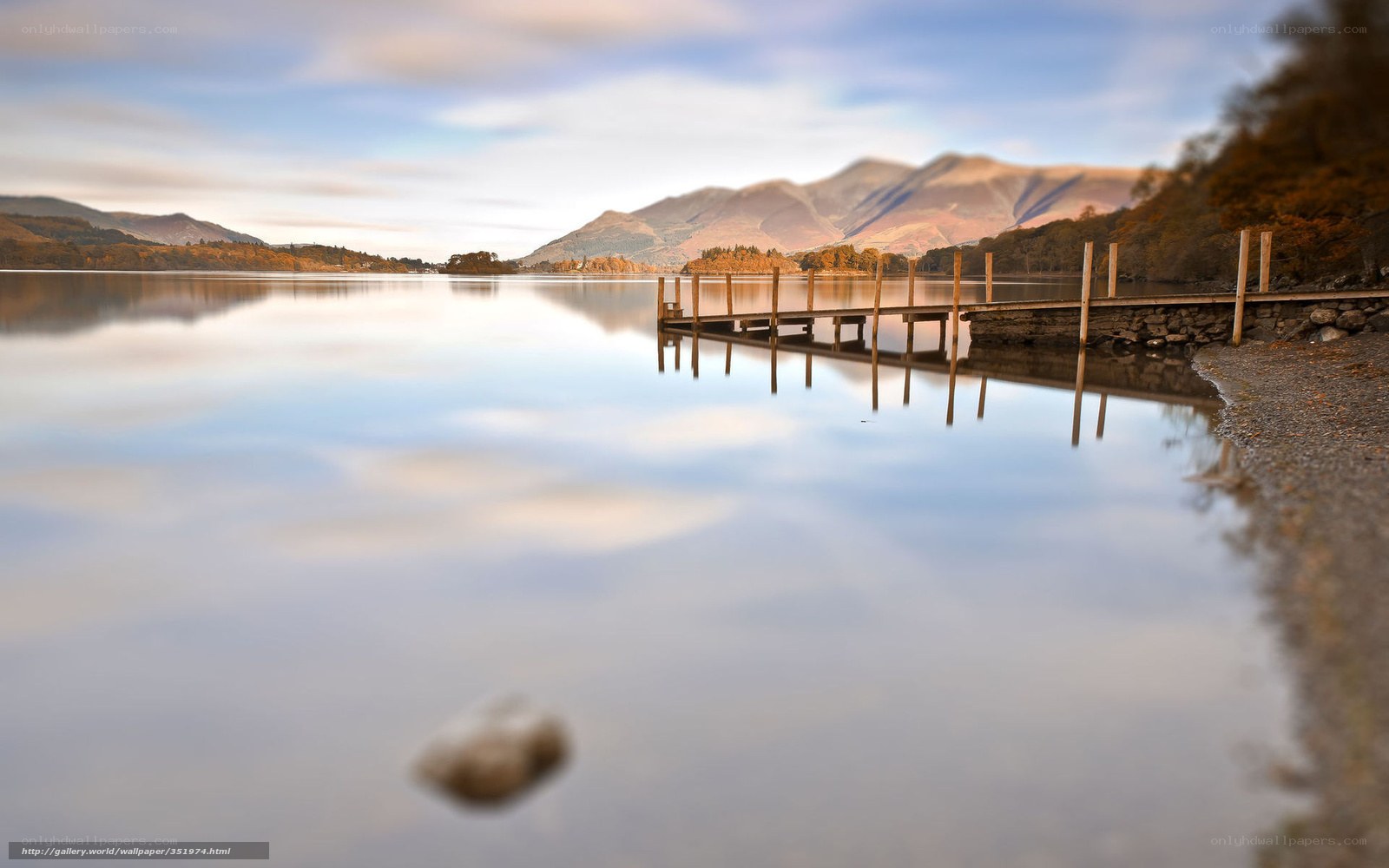 Lake with wooden pier and mountains