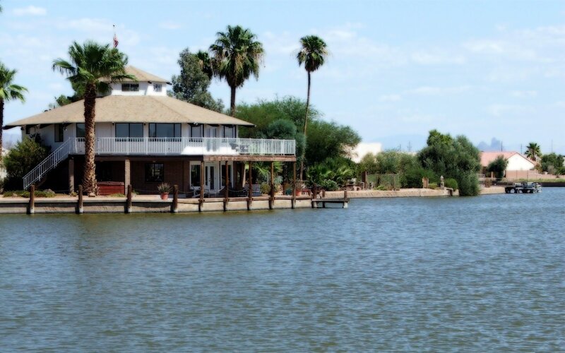 Lakefront house with palm trees
