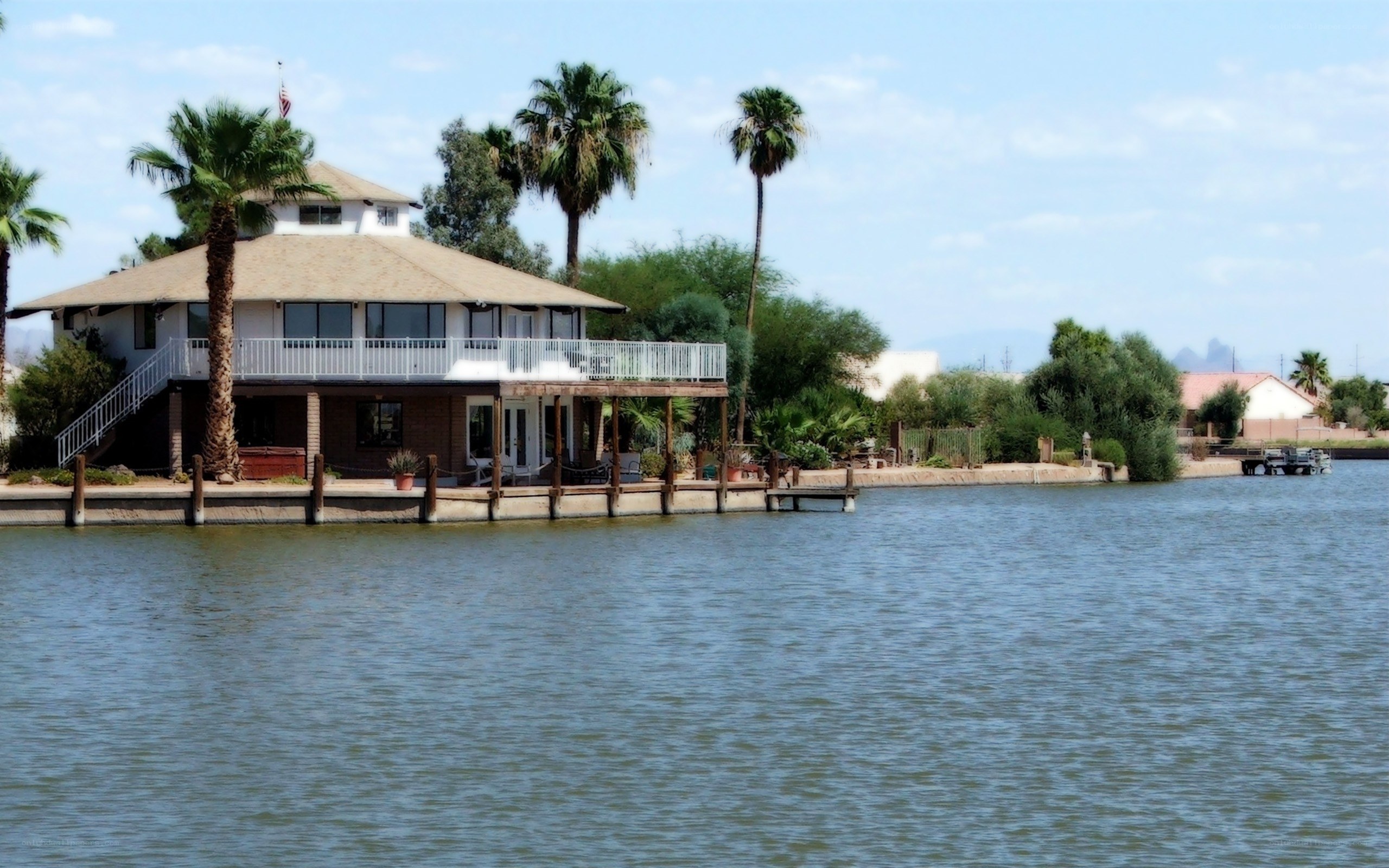 Lakefront house with palm trees