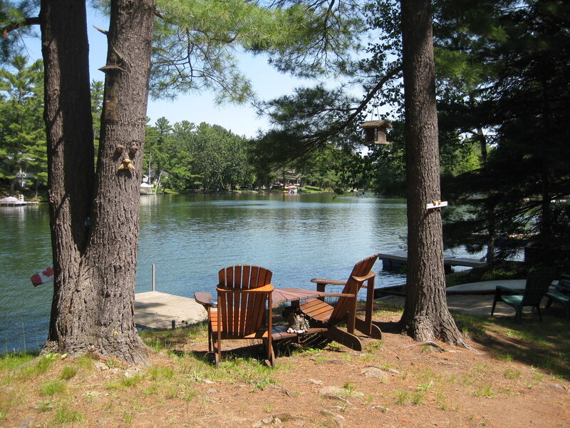 Lakefront seating area with Adirondack chairs