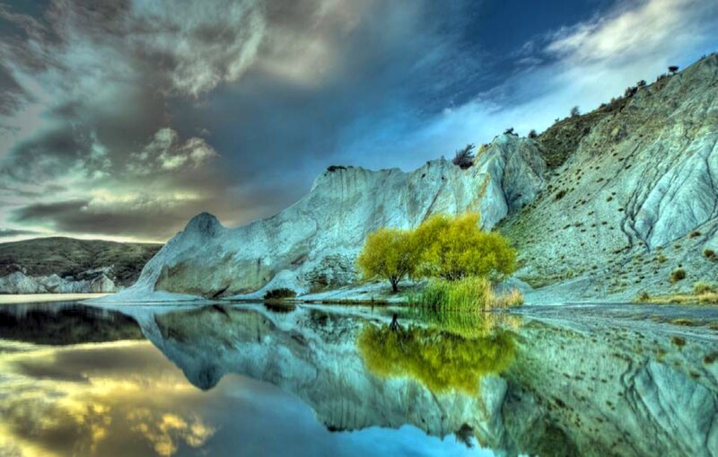 Lakeside cliffs with tree reflection