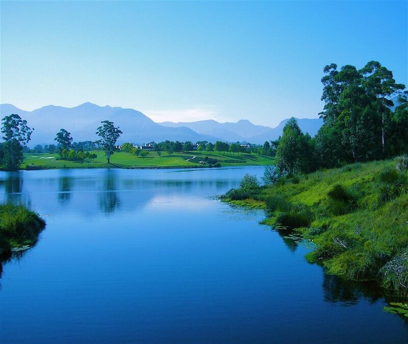 Lakeside golf course with mountains