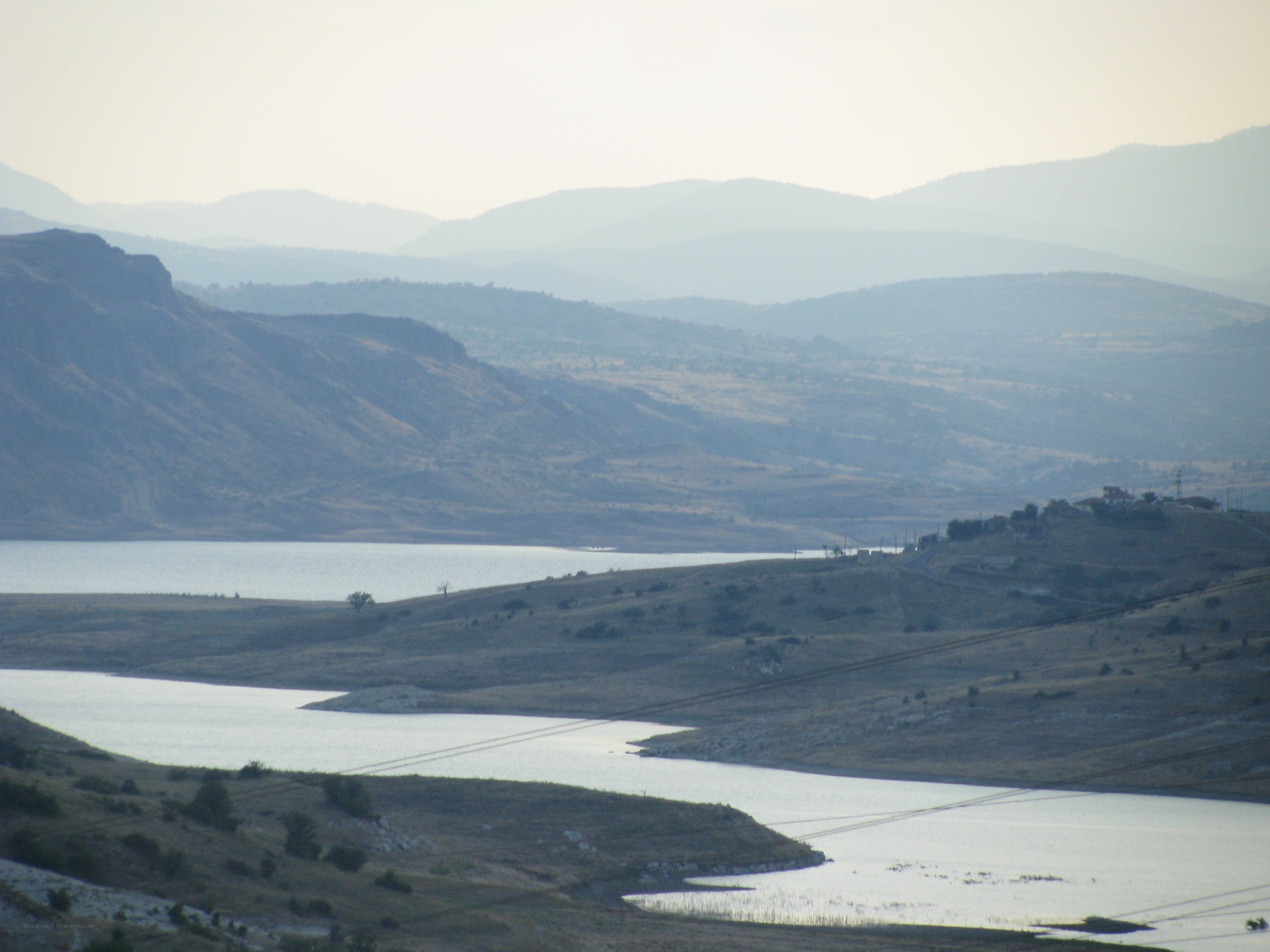 Lakeside hills with distant mountains