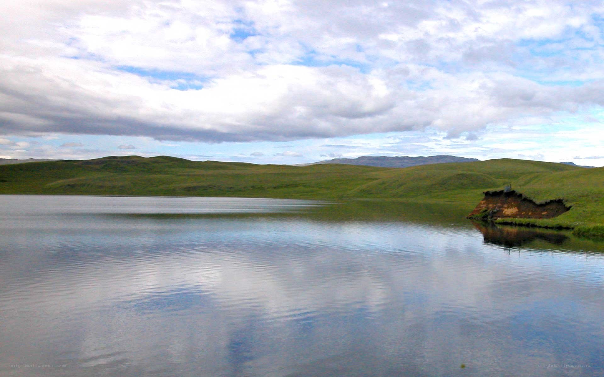 Lakeside landscape with rolling hills