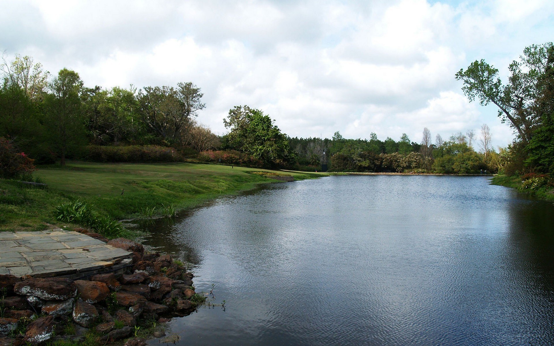 Lakeside park with green lawn