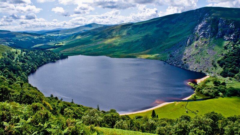 Lakeside valley with green hills