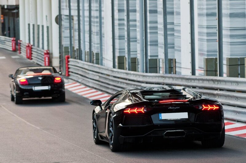 Lamborghini and Bentley on a racetrack