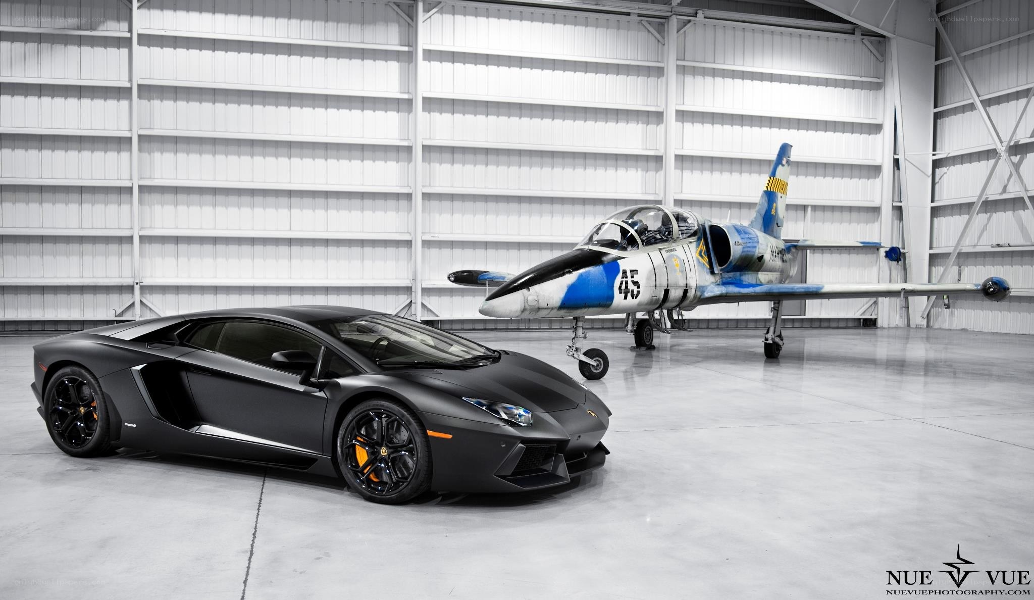 Lamborghini and jet in hangar