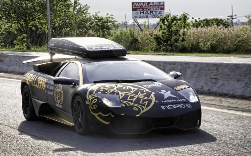 Lamborghini on a road with roof box