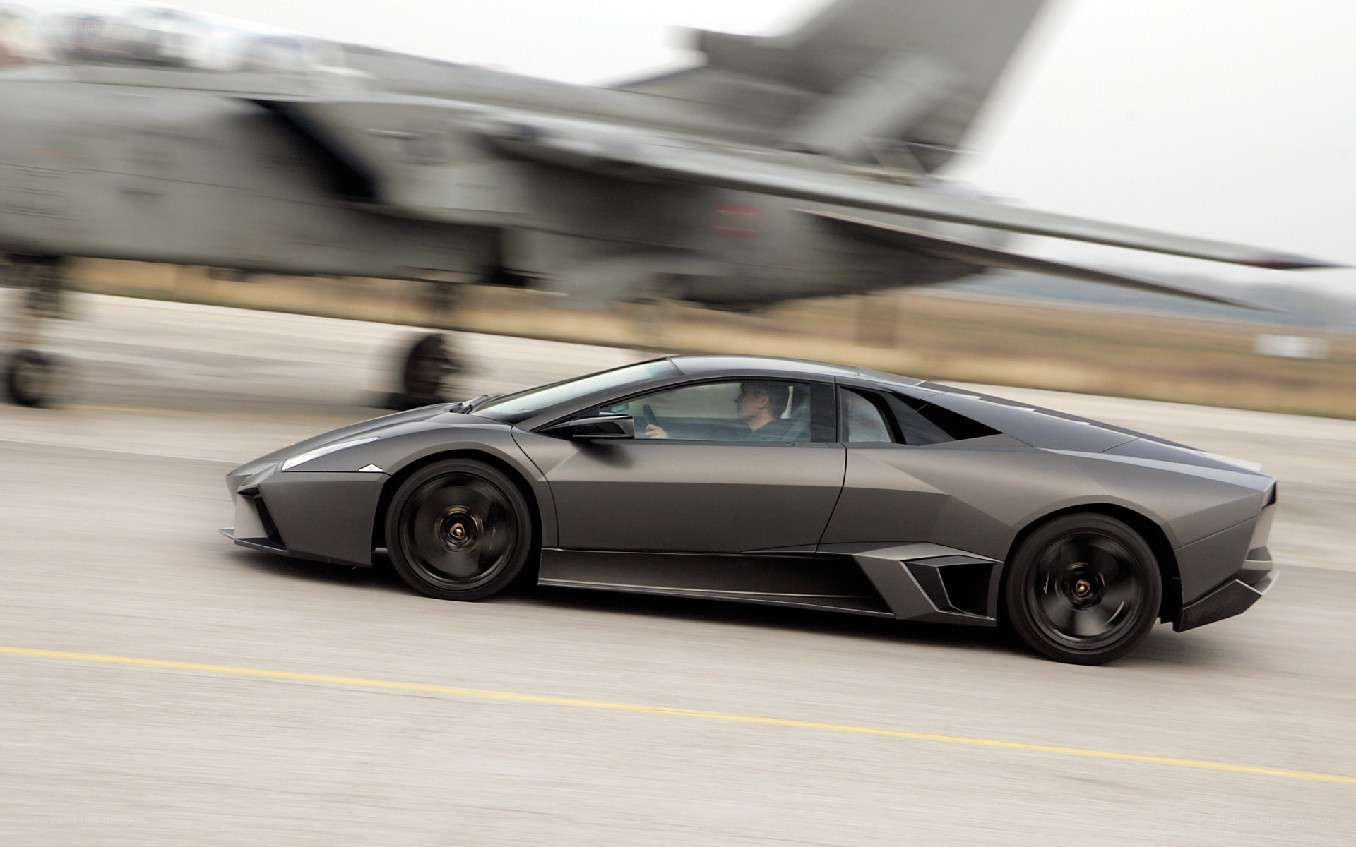 Lamborghini on runway with jet