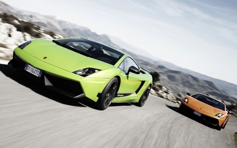 Lamborghini sports cars on a mountain road