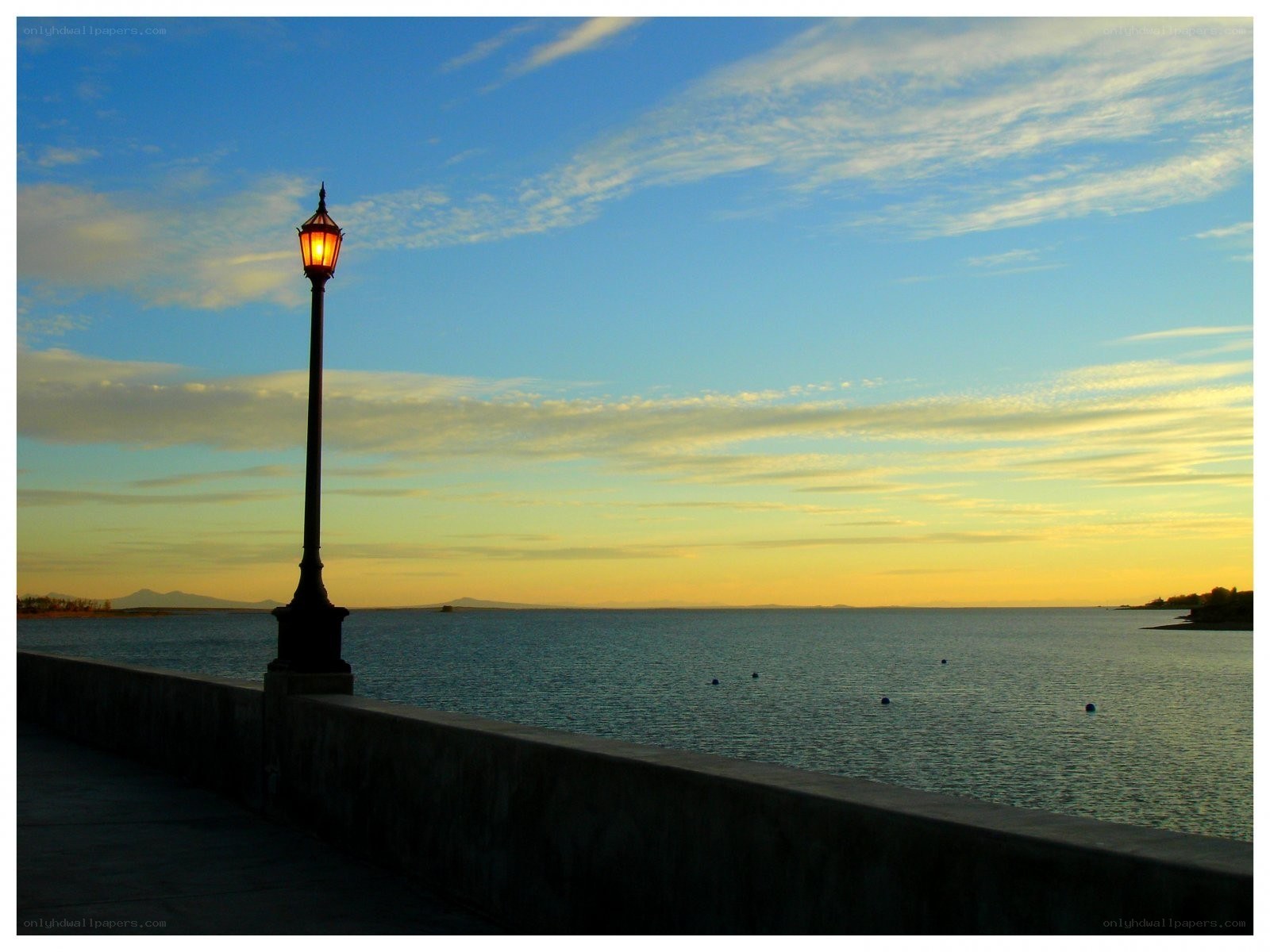 Lamp post at sunset by the water