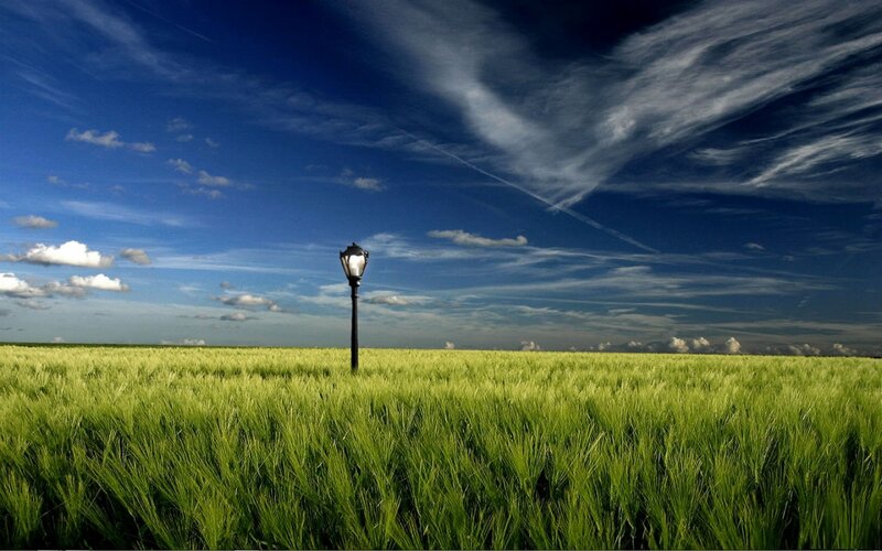 Lamp post in a green field