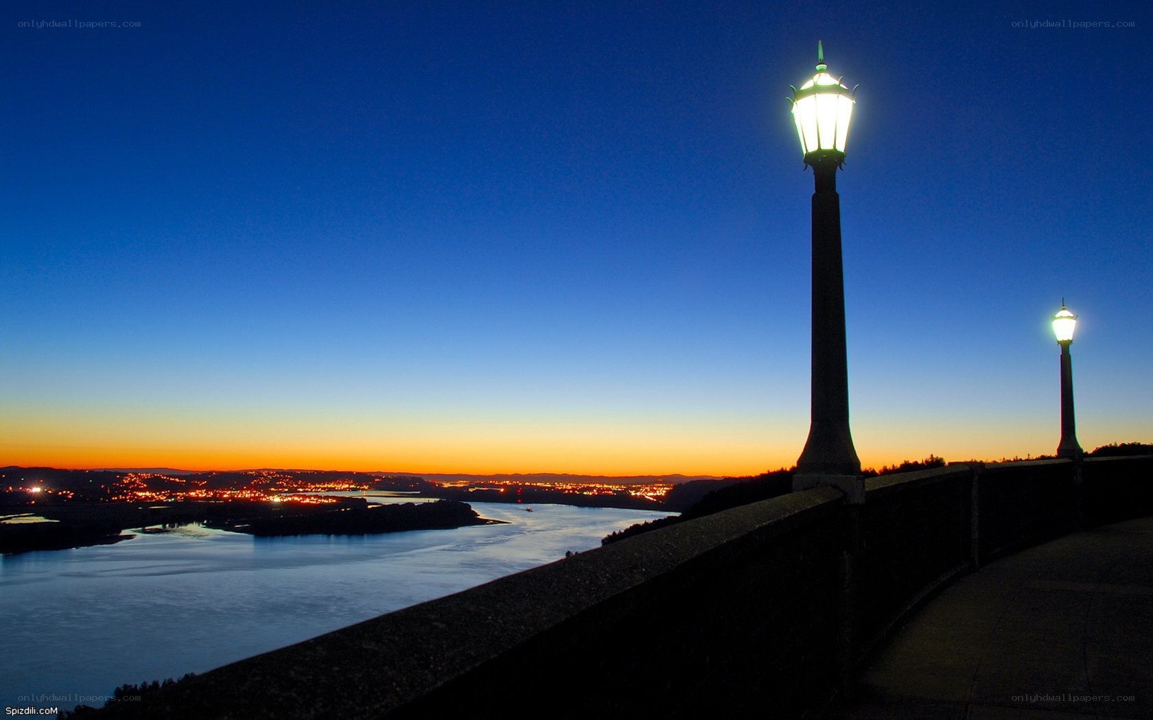 Lampposts at dusk over a river