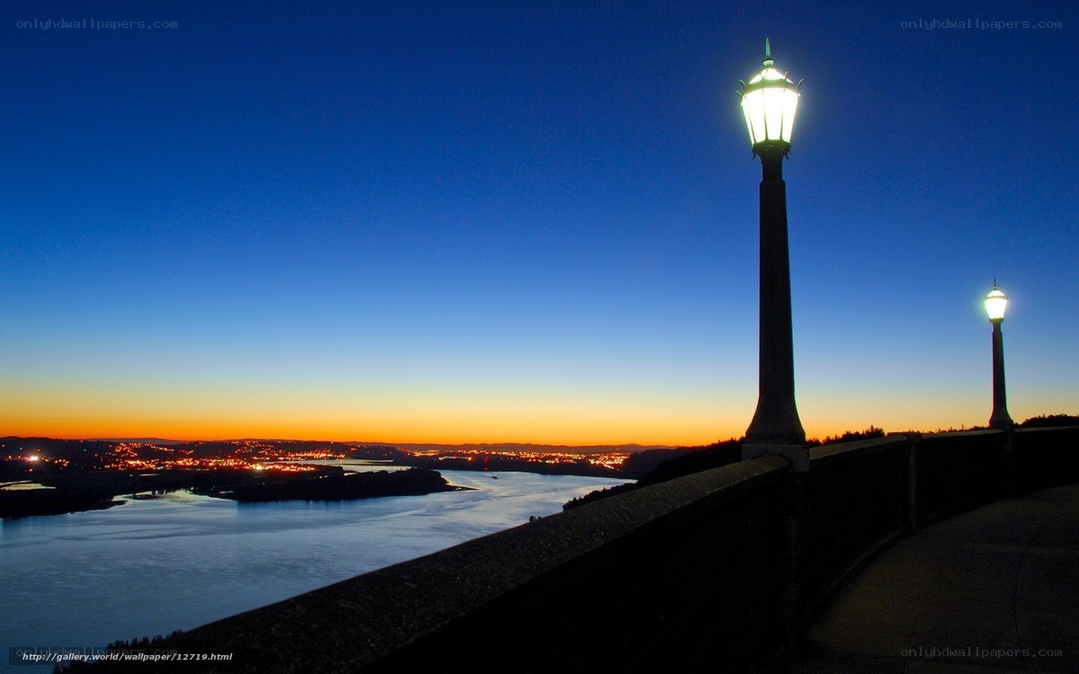 Lampposts at dusk over a river