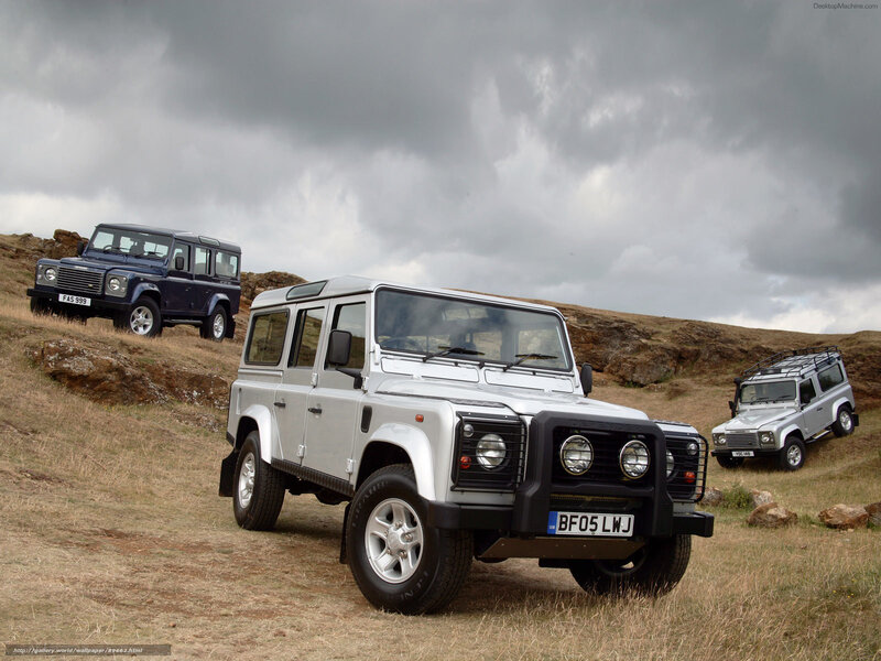 Land Rover Defenders in field