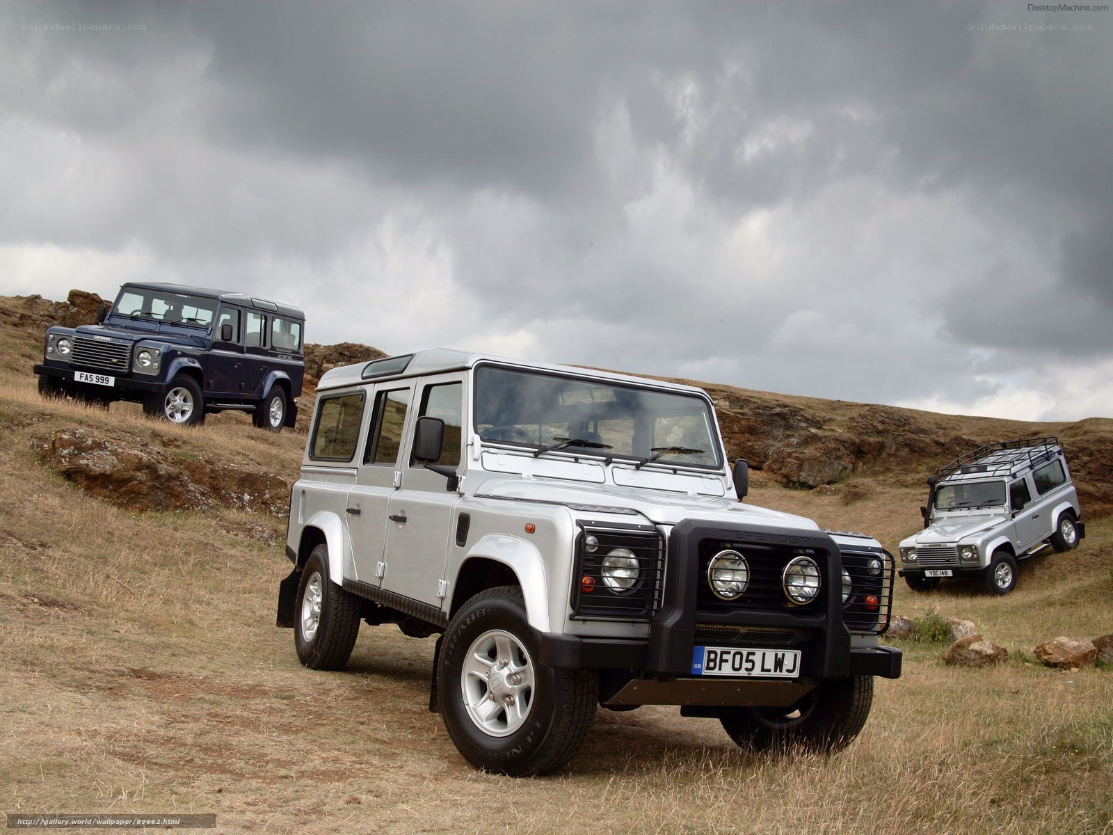Land Rover Defenders in field