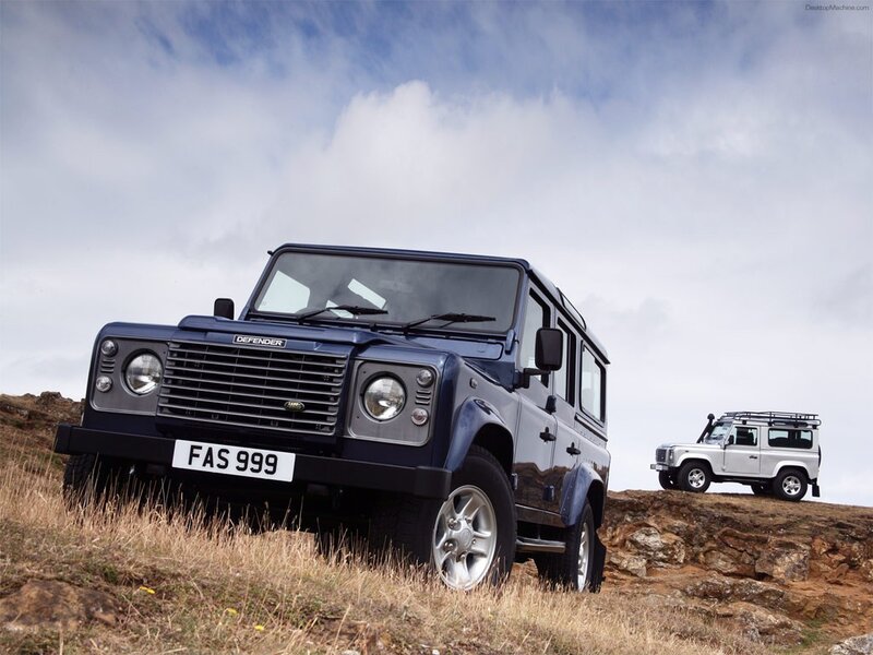 Land Rover Defenders on a hill