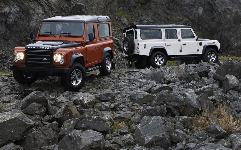 Land Rover Defenders on rocks