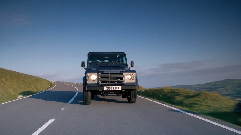 Land Rover driving on a country road