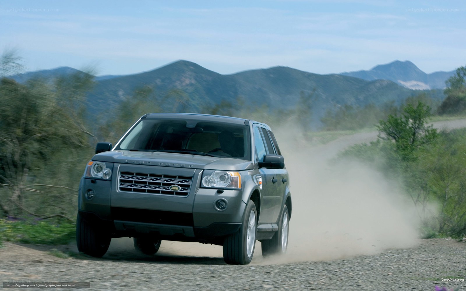Land Rover driving on dirt road