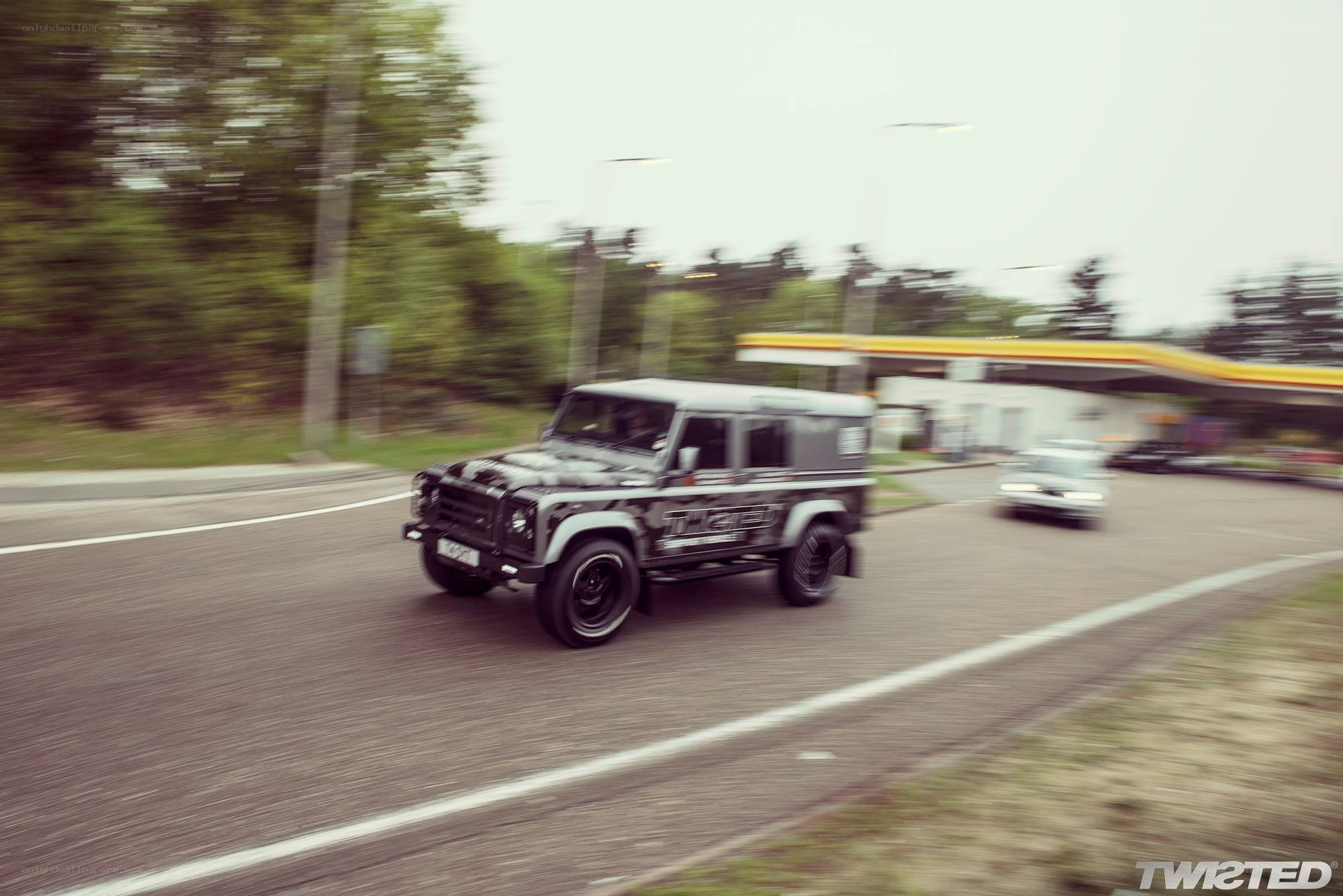 Land Rover driving on road
