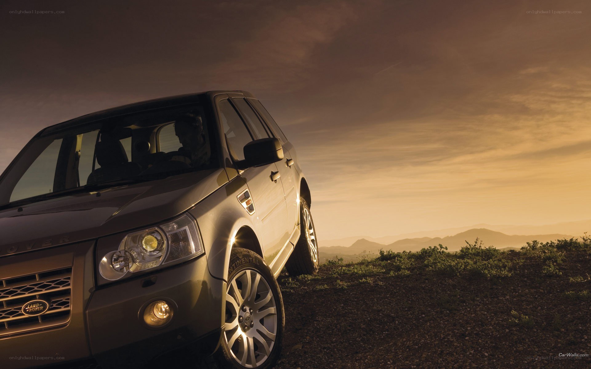 Land Rover in sunset landscape
