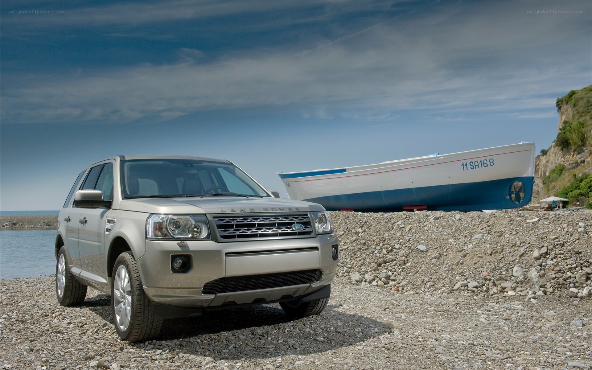 Land Rover on a pebble beach