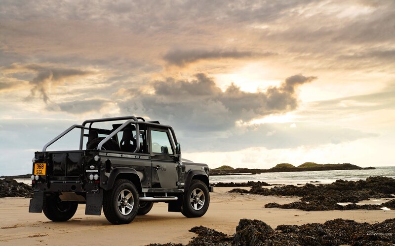 Land Rover on beach at sunset