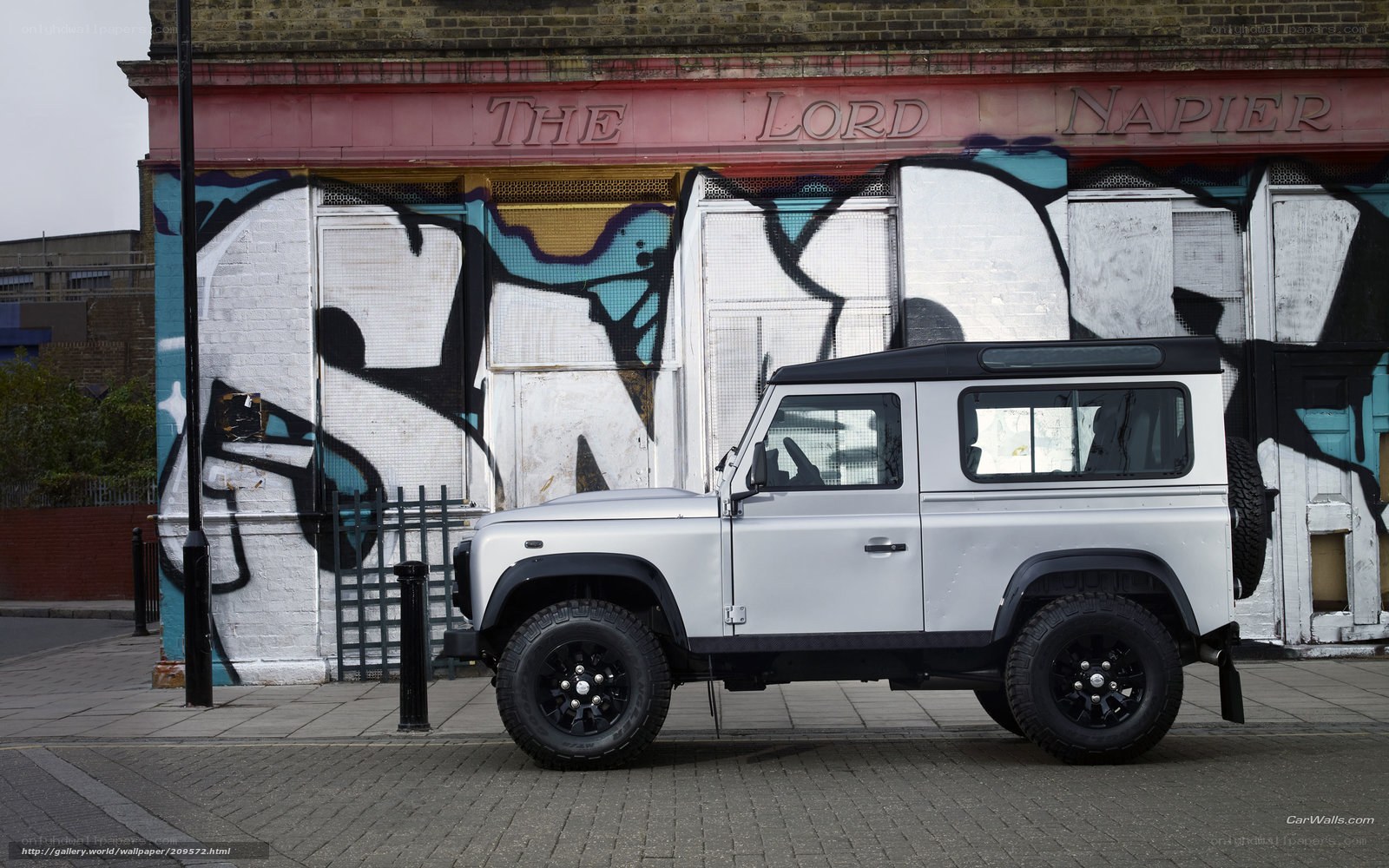 Land Rover parked in front of graffiti