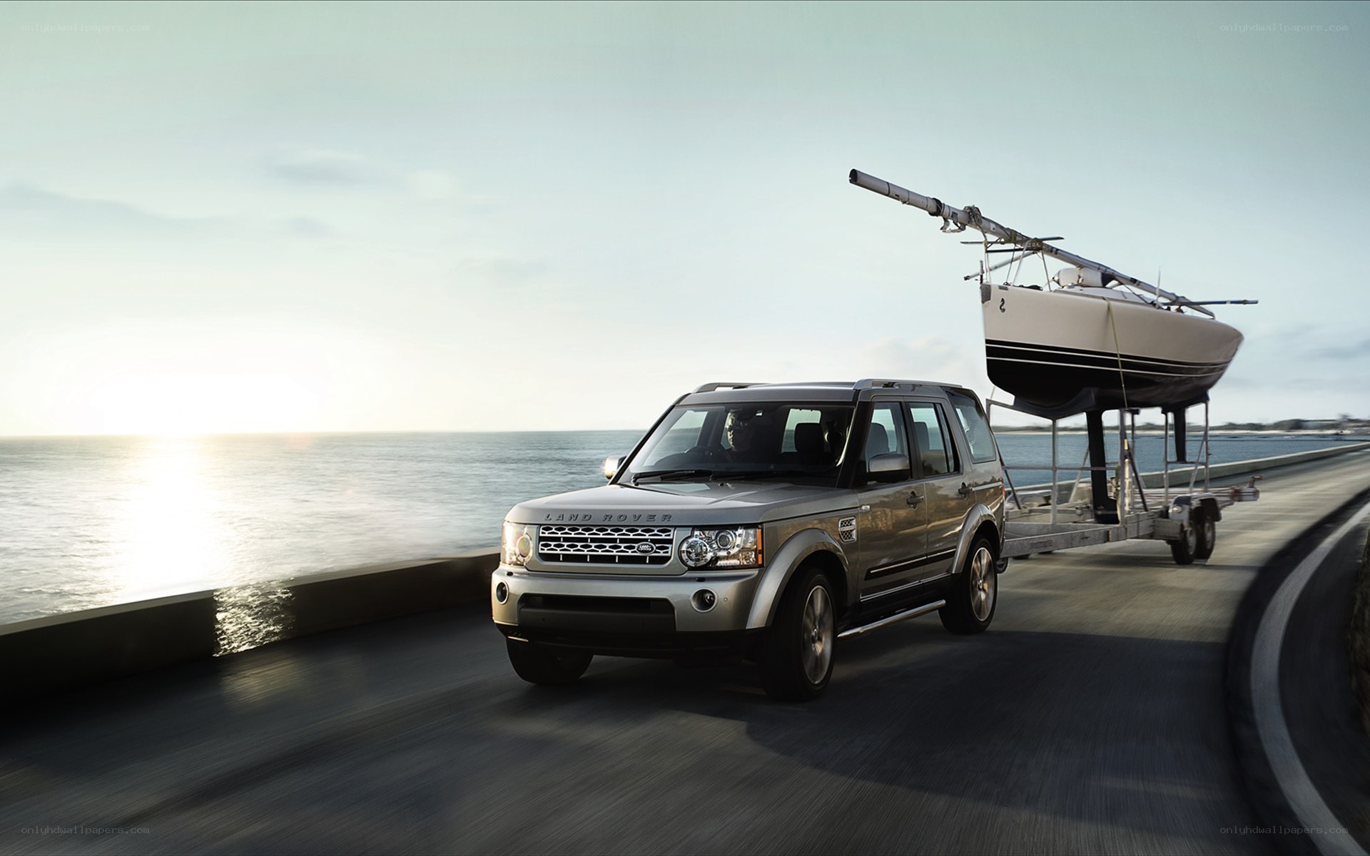 Land Rover towing sailboat