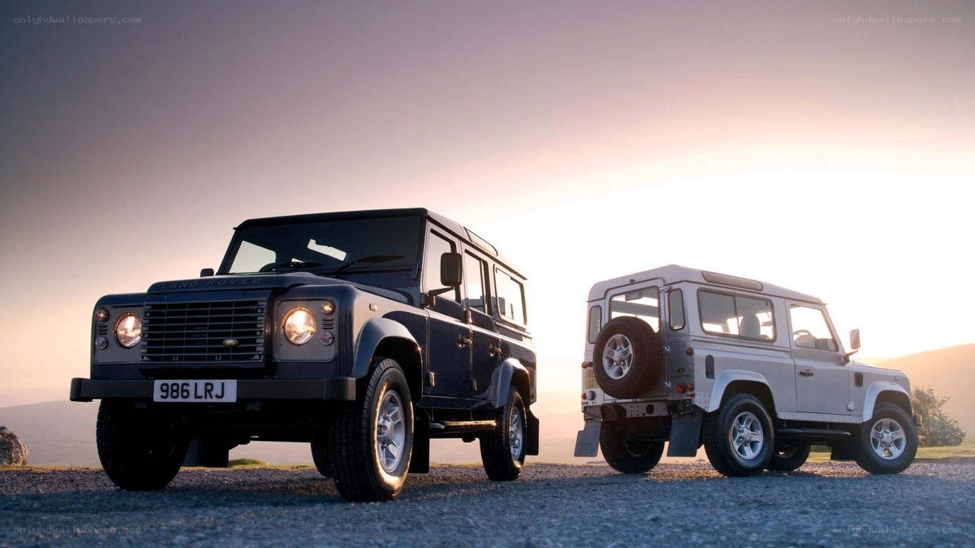 Land Rover vehicles at sunset