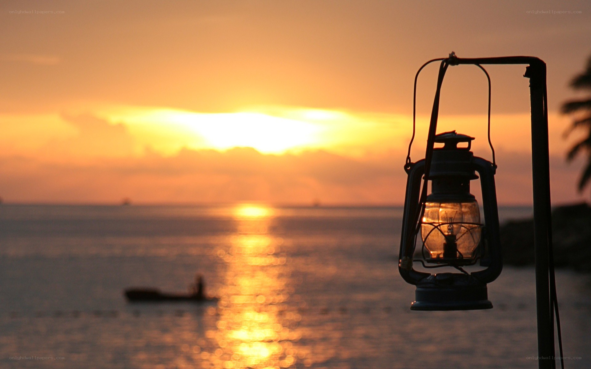 Lantern at sunset by the sea