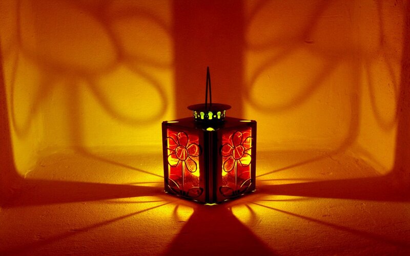 Lantern casting floral shadows
