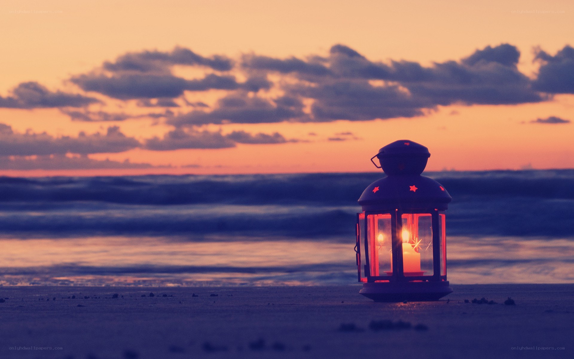 Lantern on the beach at sunset