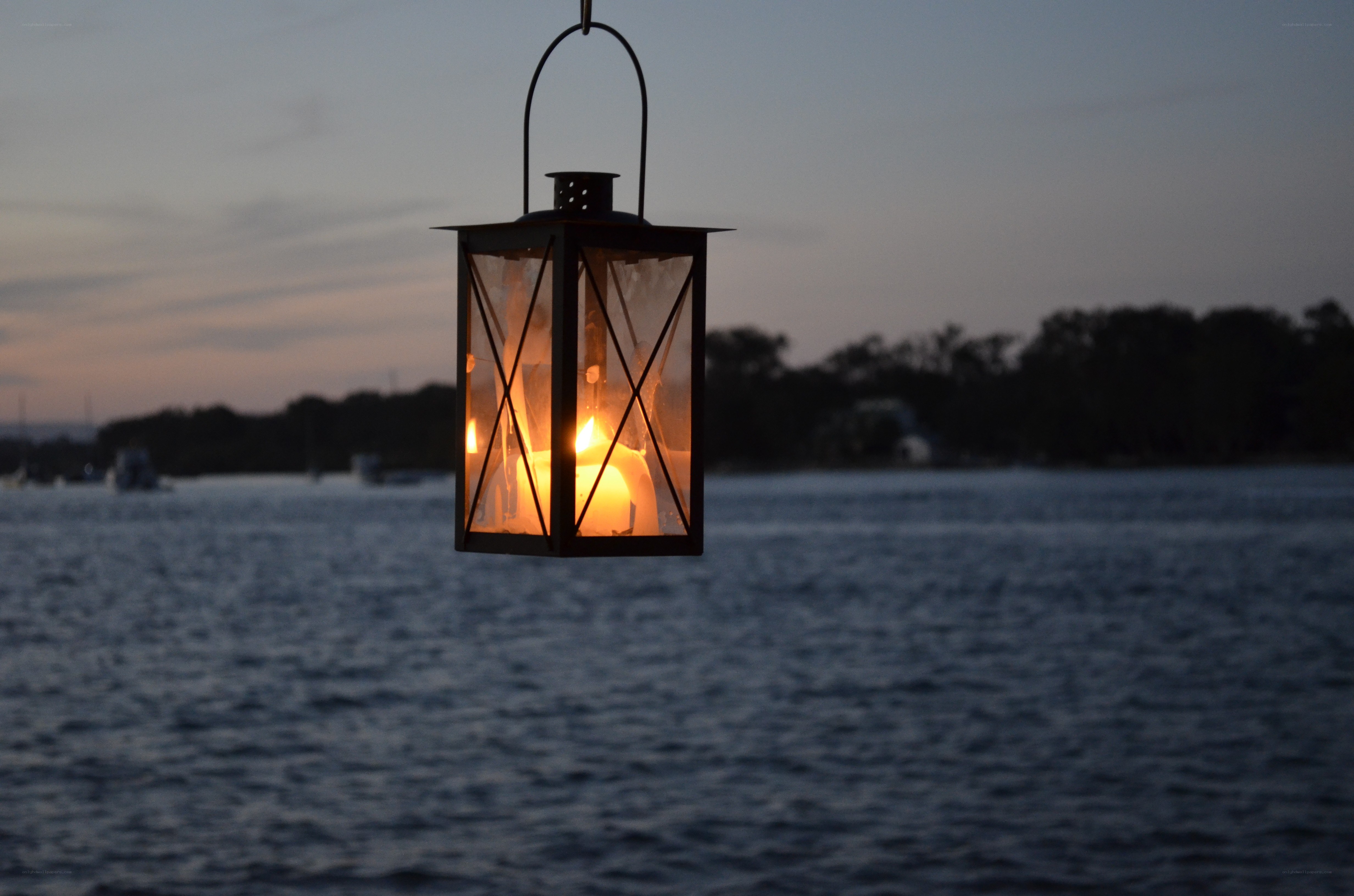 Lantern over the water at dusk