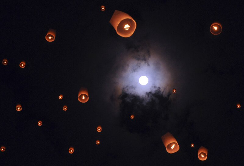 Lanterns floating under moonlight