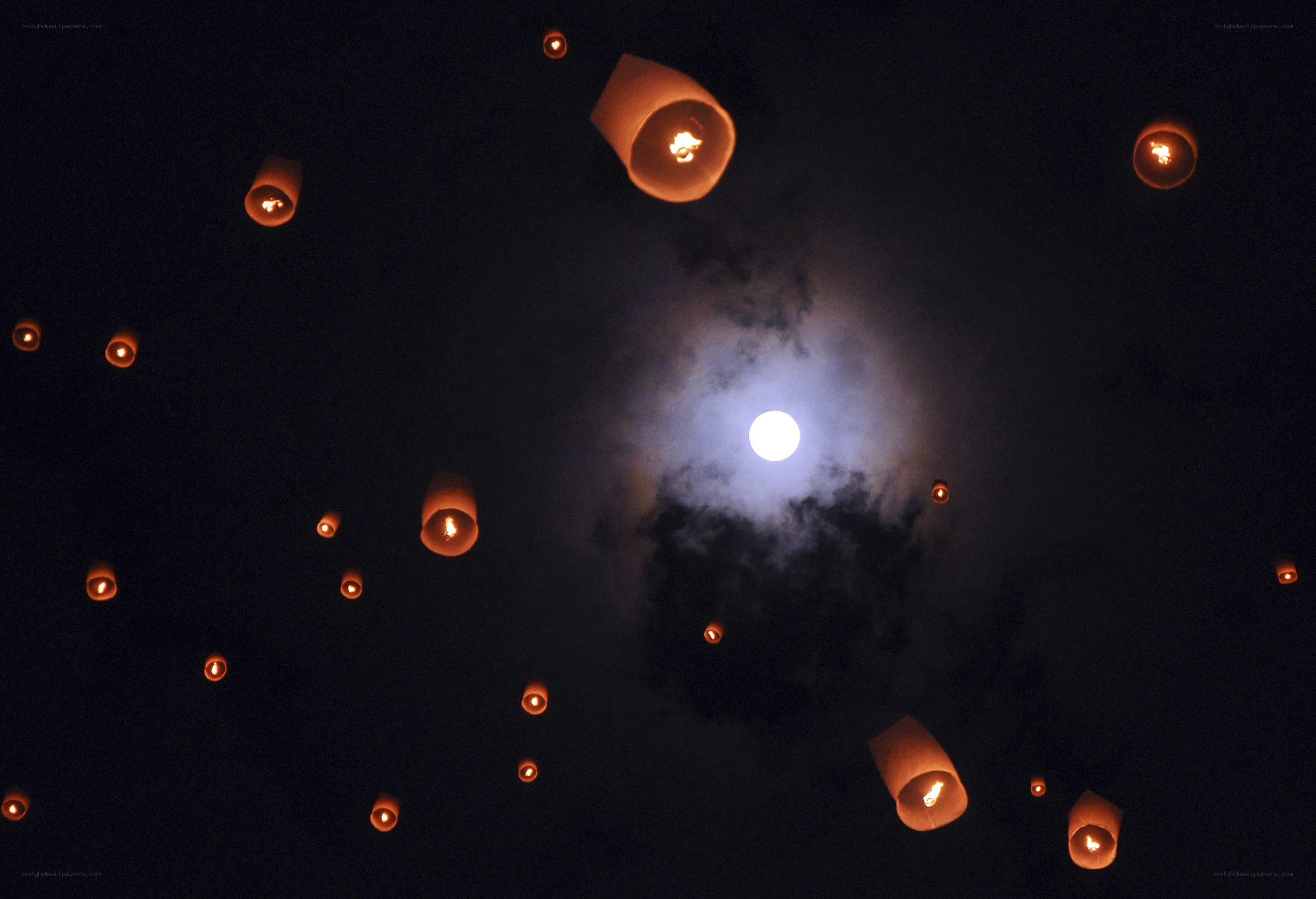 Lanterns floating under moonlight