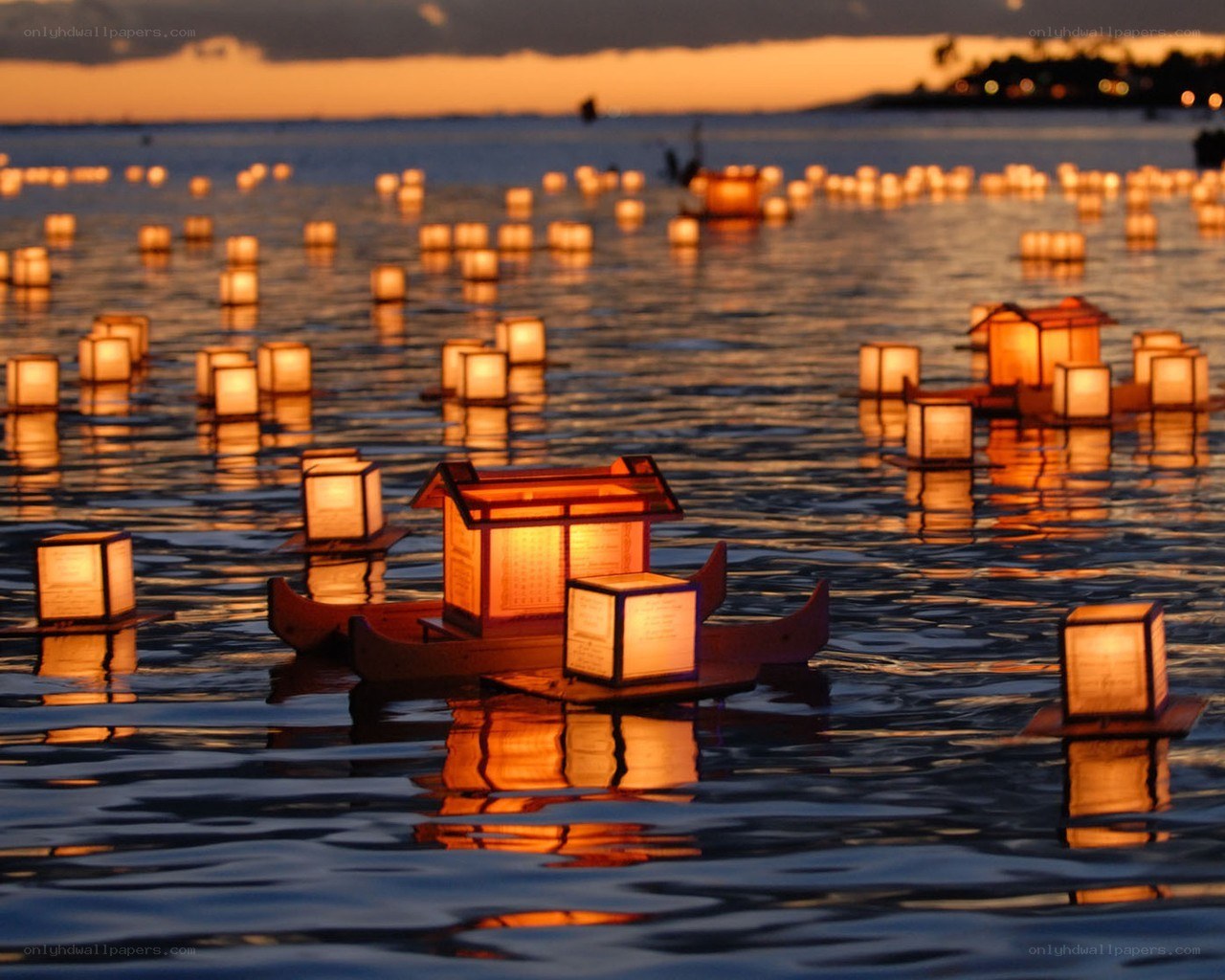 Lanterns on the water at dusk