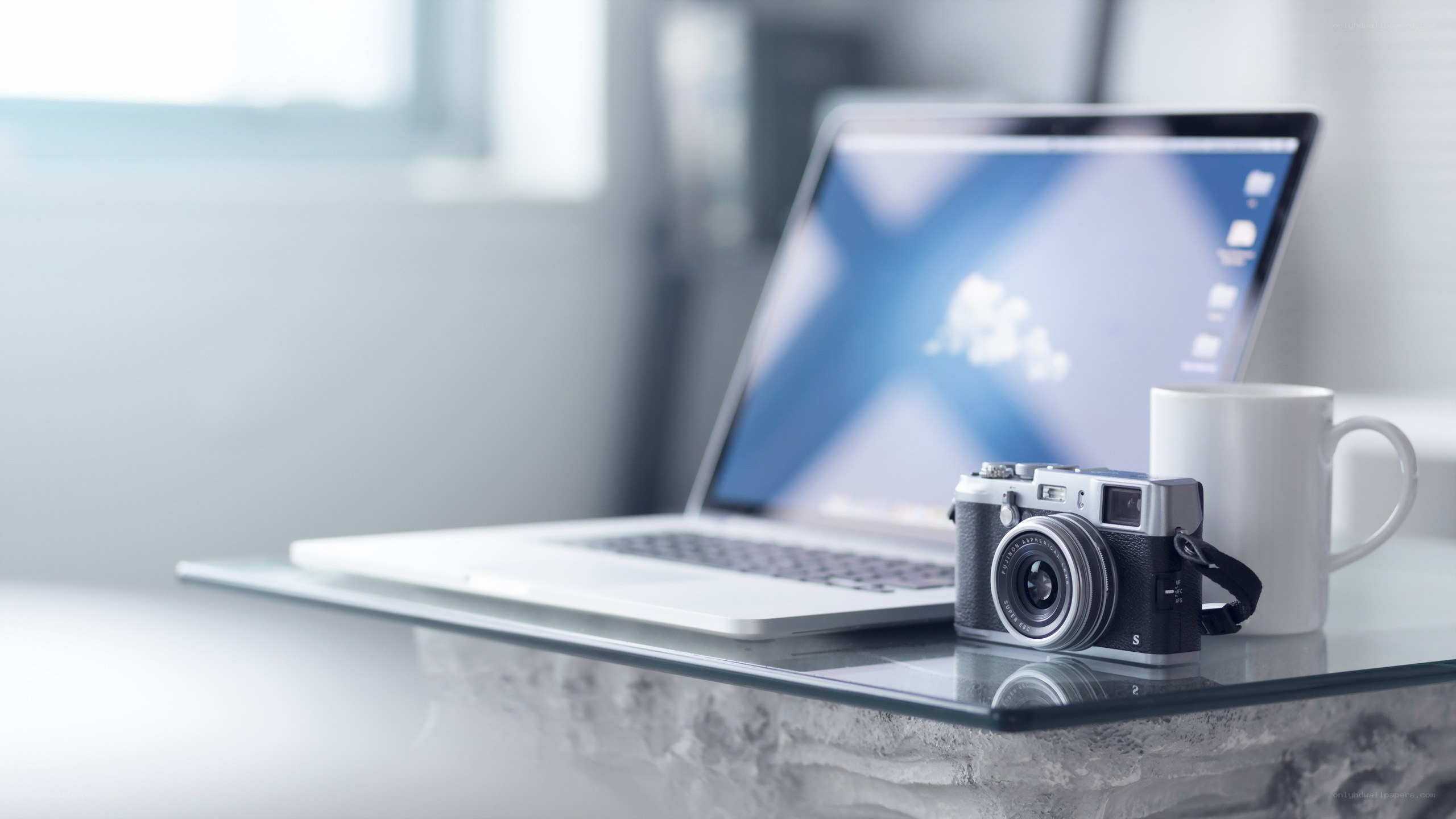 laptop and camera on desk