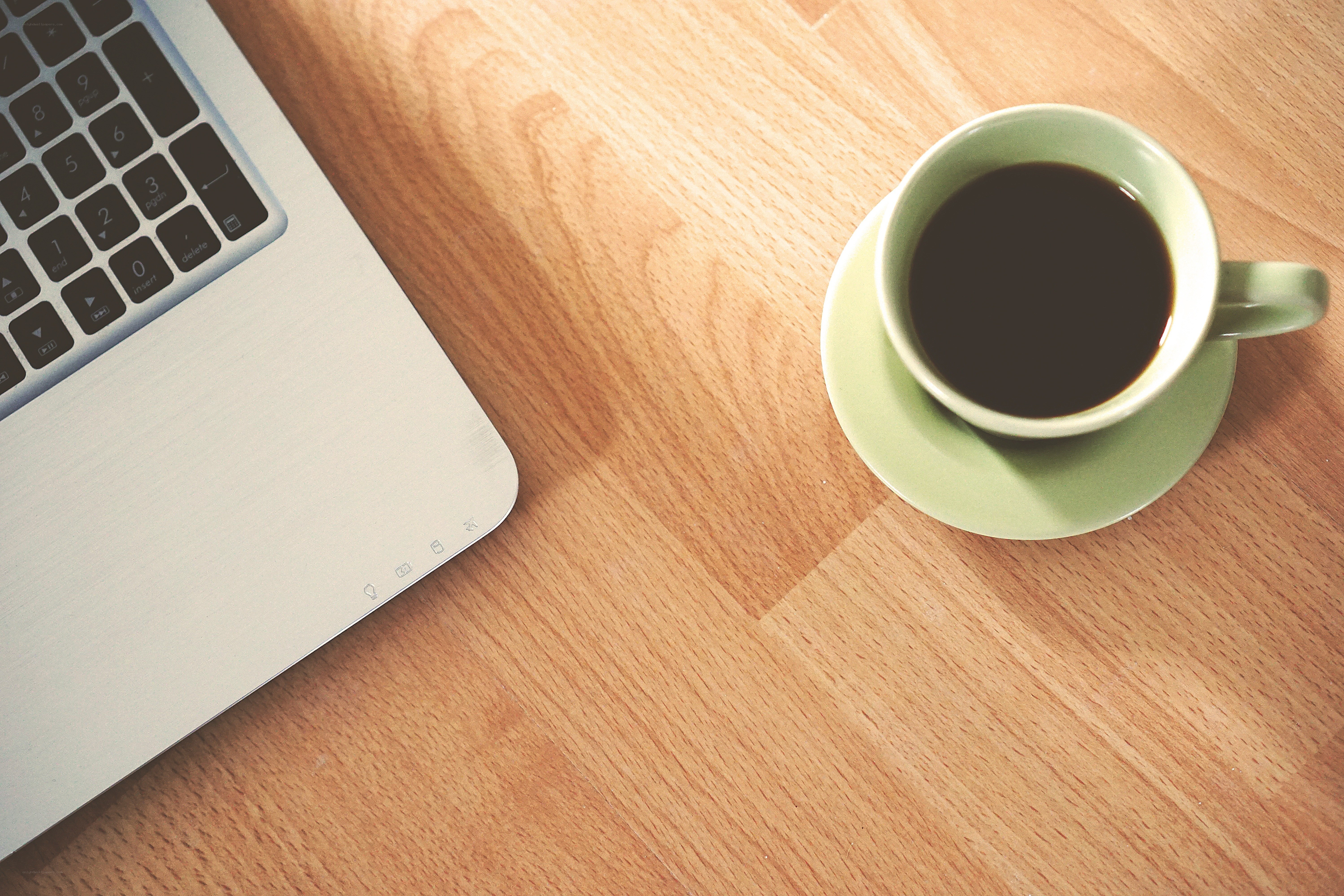 laptop and coffee cup on desk