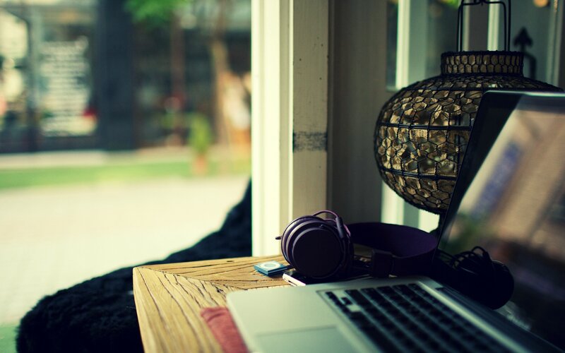 laptop and headphones by window