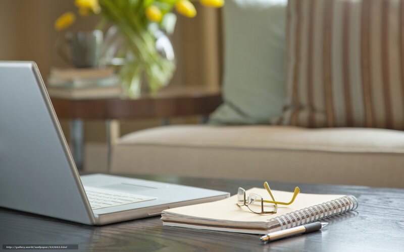 Laptop and notebook on table